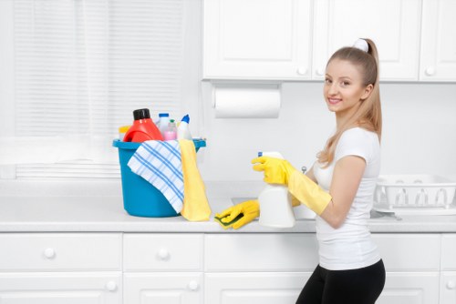Cleaner preparing carpet cleaning equipment with safety precautions in place