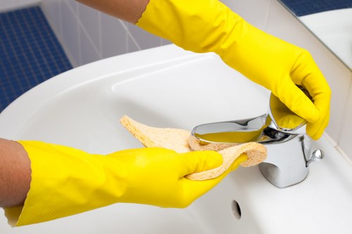 Technician treating sofa stains during Woodside upholstery cleaning